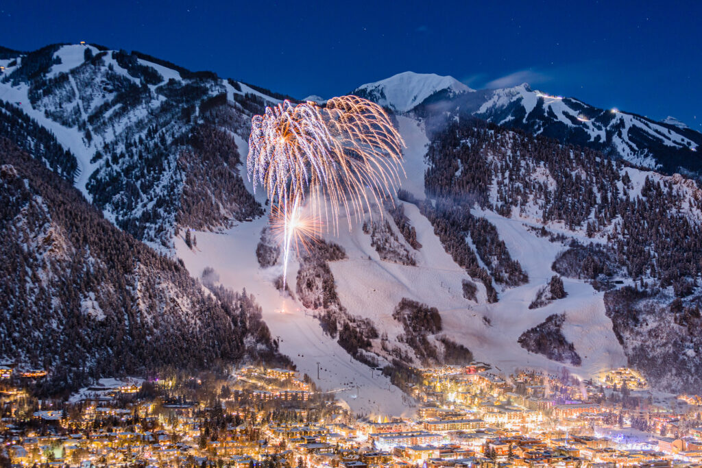 Fireworks over the town of Aspen with Aspen Mountain in the winter. 