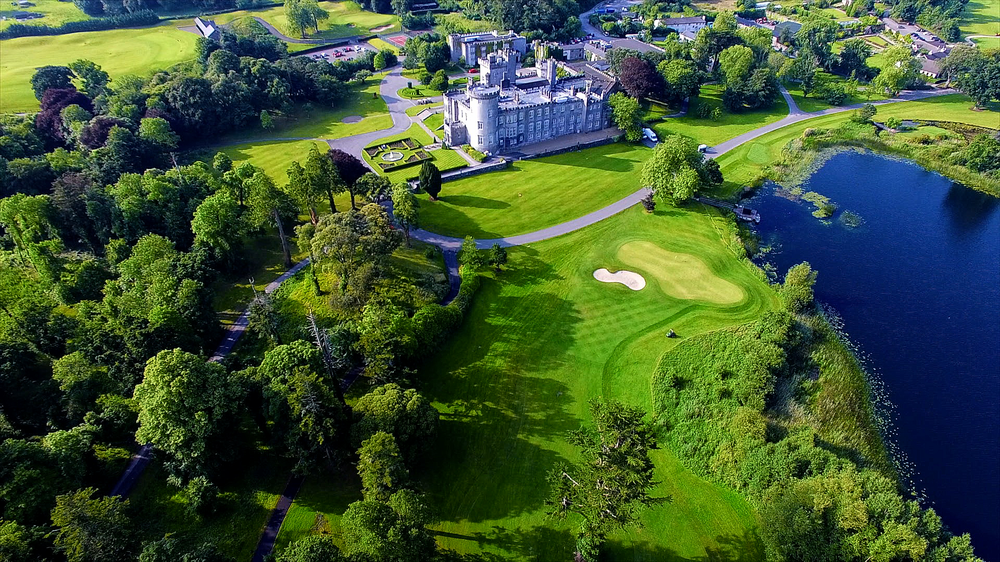 Aerial view of Dromoland Castle hotel grounds with the main castle and surrounding golf course.