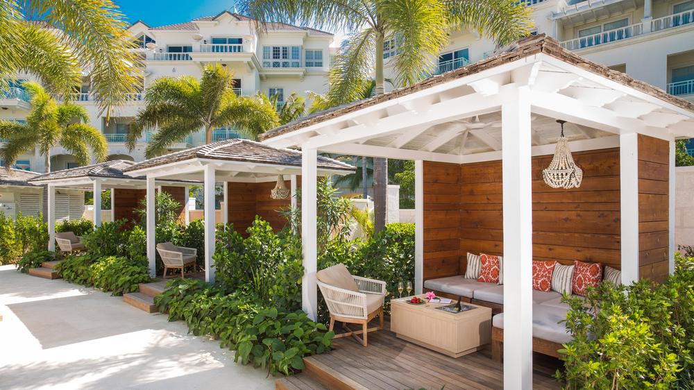 The Shore Club pool and lounge area with covered cabanas with sitting area and small sea shell chandeliers. 