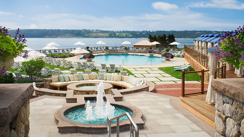 Outdoor pool, lounge furniture, and water fountain at Wequassett Resort & Golf Club in Cape Cod, Massachusetts.
