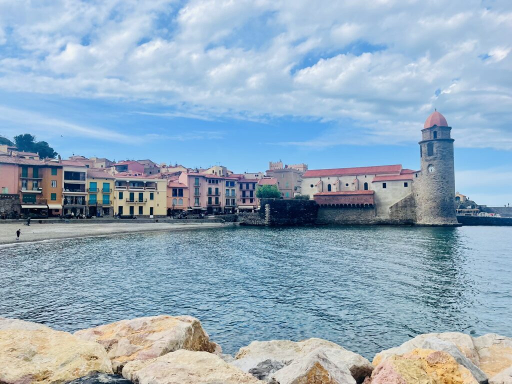 View of Collioure, France from a pile of boulders that extend into the water