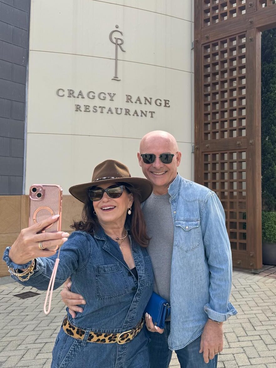 Inspirato members taking a selfie in front of the Craggy Range Restaurant entrance and sign