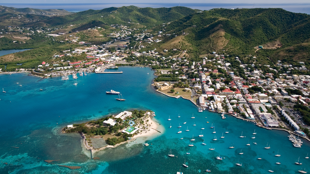 Aerial view of Christiansted, St. Criox bay with lots of anchored boats in the water and a town built around the shore