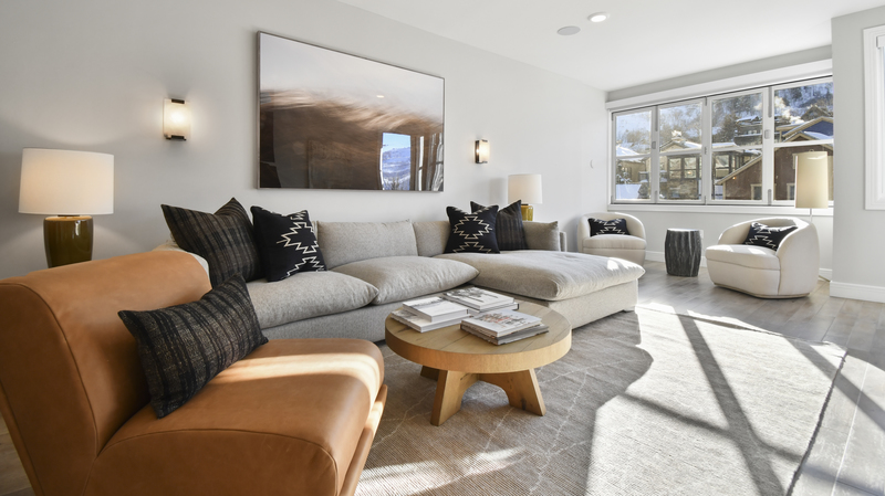 High West living room with furniture lined against the wall with a small circular wooden coffee table