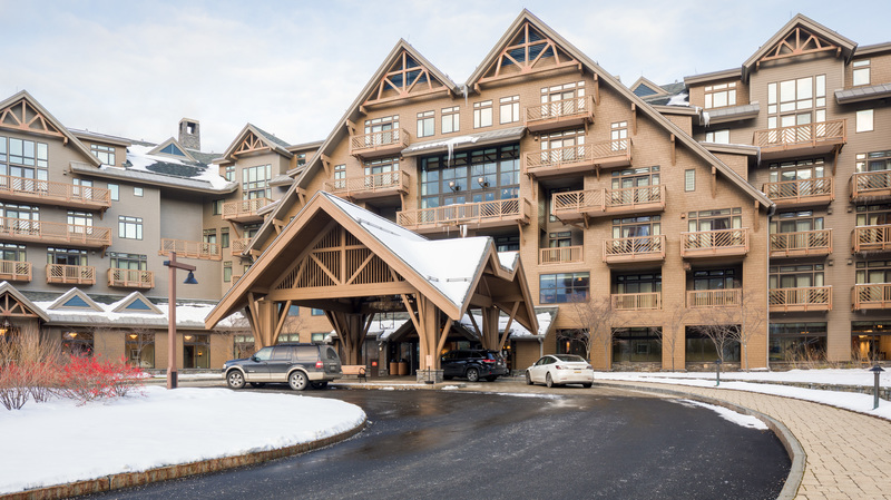 Exterior of Lodge at Spruce Peak with the drive up entrance in the winter