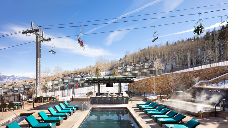 Slope side Vicreoy Snowmass pool area during winter with a chairlift above the pool. 