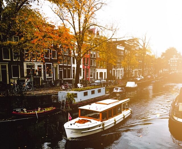 The canals of Amsterdam with autumn colored leaves