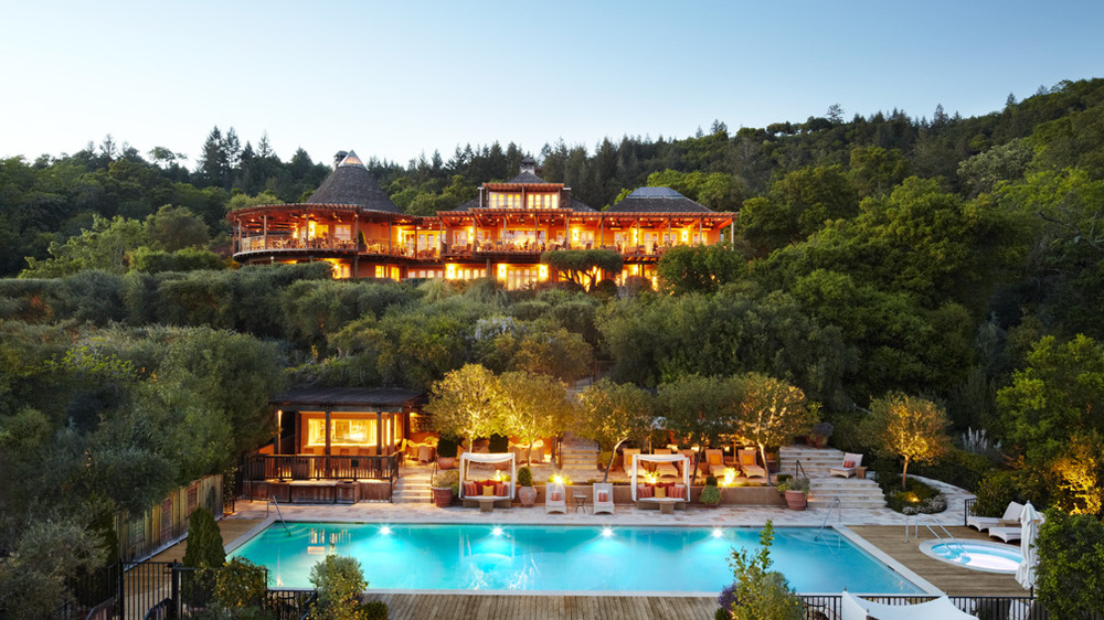 Auberge du Soleil pool area and exterior of the main building with surrounding forest.