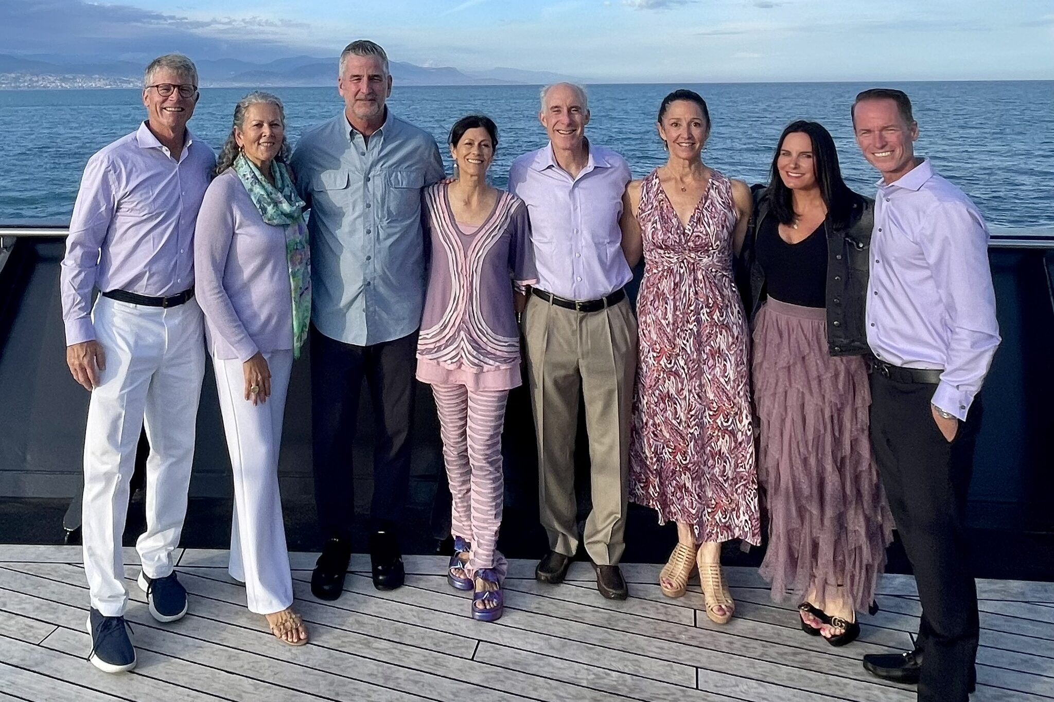 A group shot on a deck of a boat.