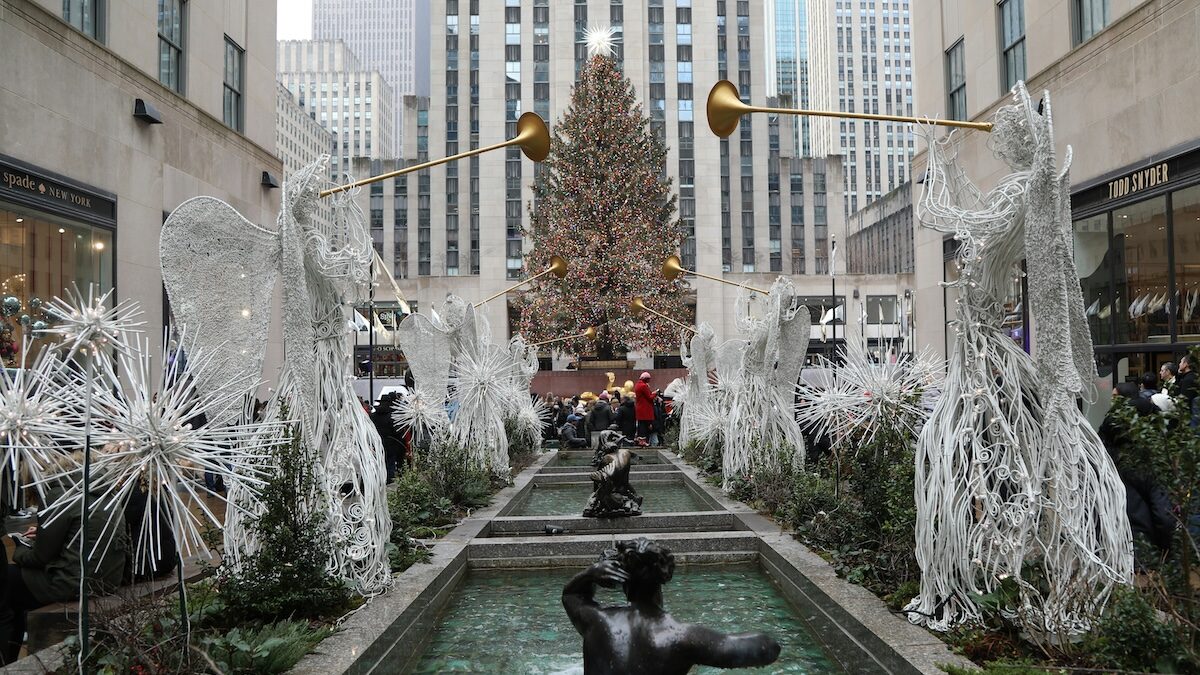 Fountains in front of Rockefeller Center with the Rockefeller Christmas tree with holiday decorations.