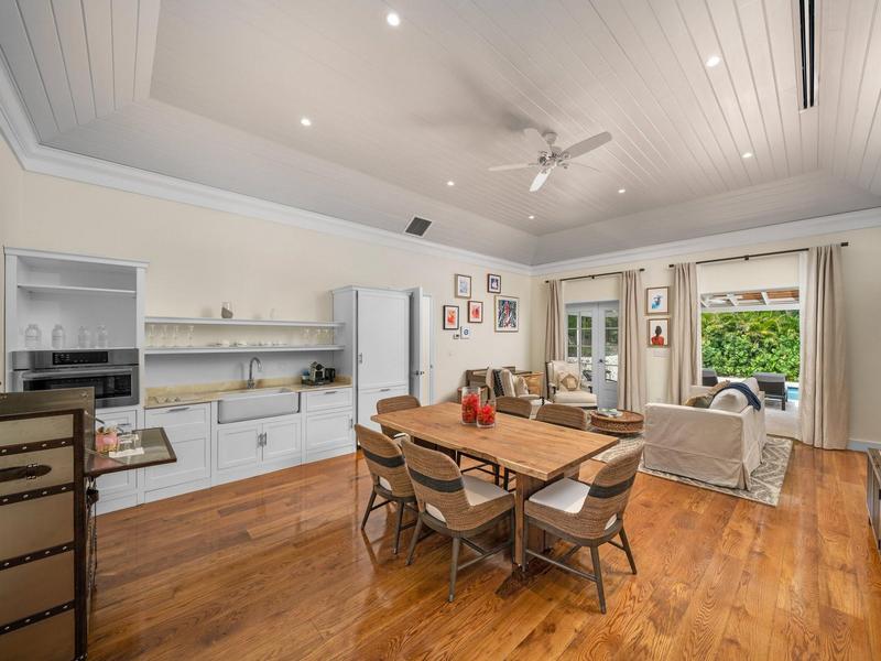 Living area of Frangipani Villa with dining room, small kitchen, and living area. 